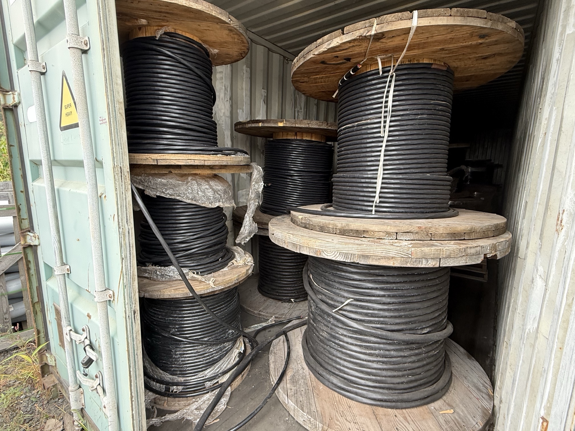Large black cable reels stored in a container