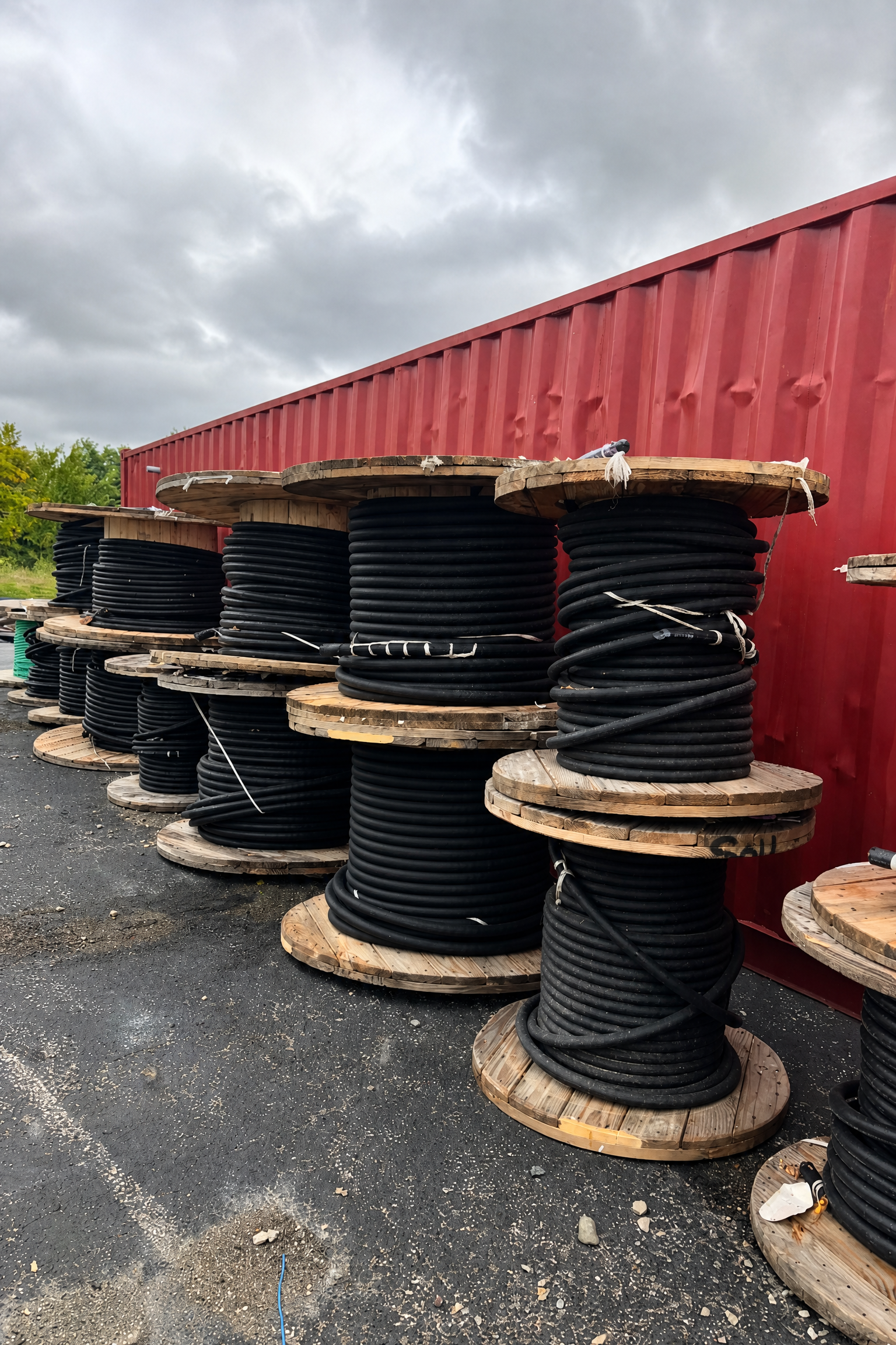 Surplus electrical cable reels staged outdoors for condition review